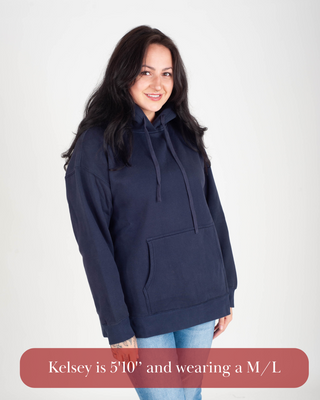 Woman wearing a navy blue hoodie on a white background