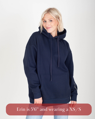 Woman wearing a navy blue hoodie on a white background