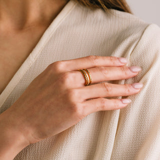 women wearing a gold layered ring