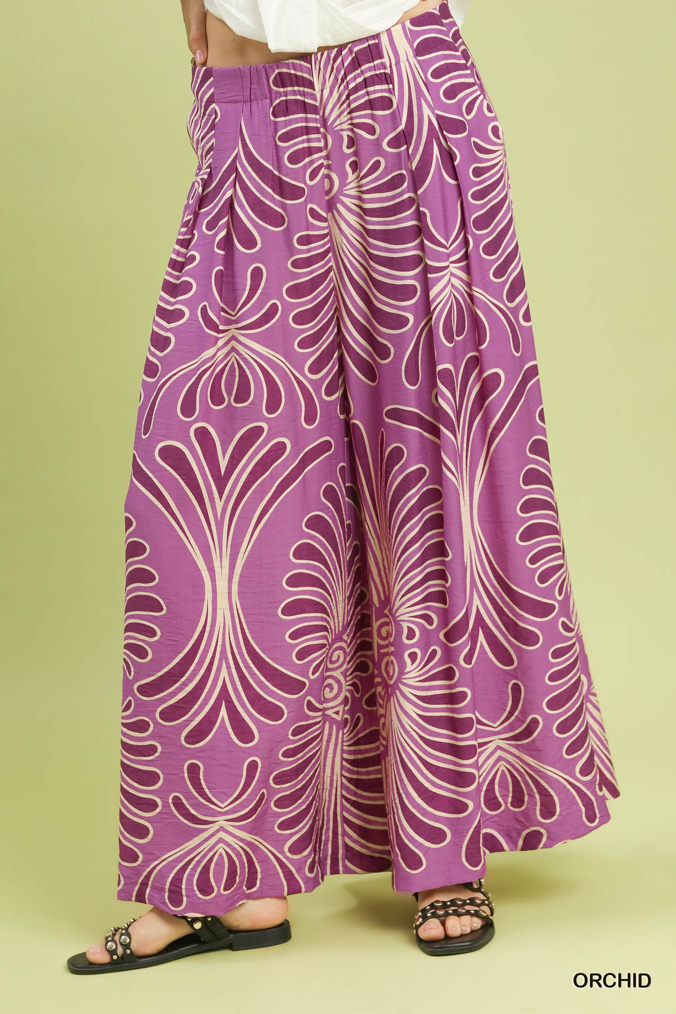 Purple patterned pants on a green background