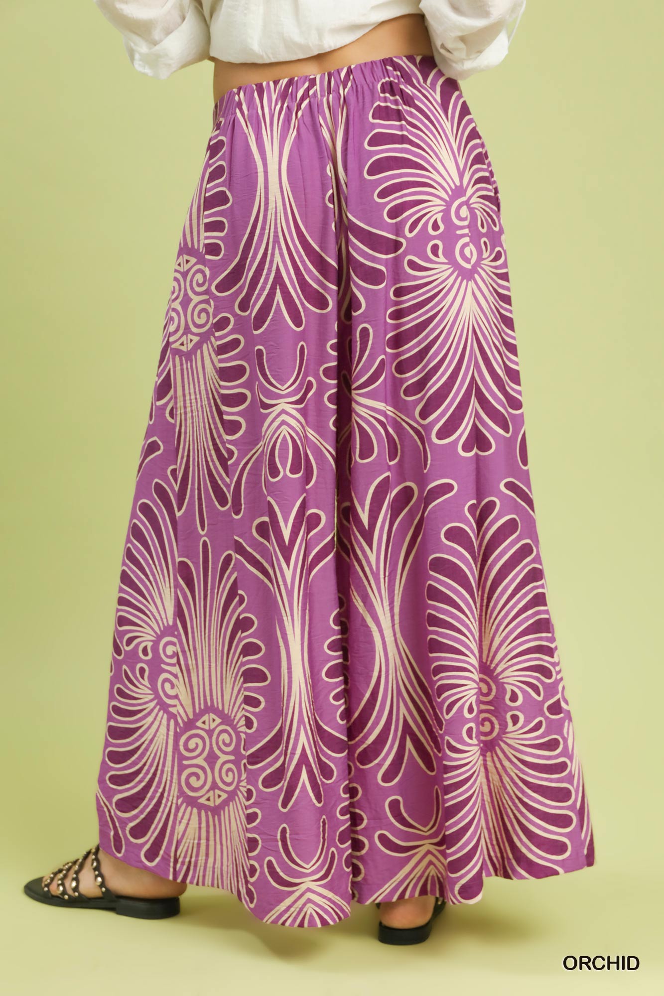 Purple patterned skirt on a green background