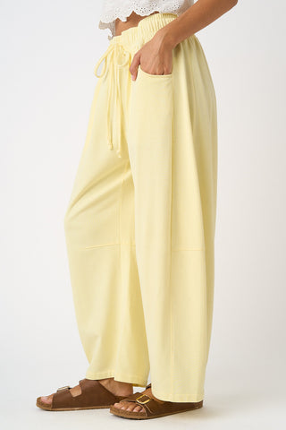 Light yellow pants worn by a person on a white background
