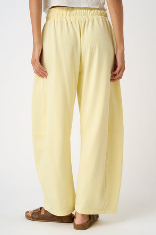 Light yellow pants worn by a person on a white background
