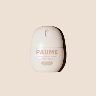 Paume hand sanitizer mist on a neutral background.