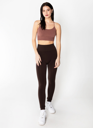 A woman is standing wearing bamboo high-waisted leggings. 