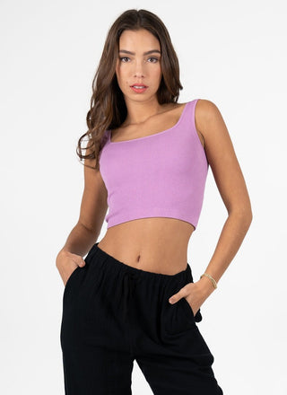 A woman wearing a square neck crop tank in a light blue color, with the tank displaying a ribbed texture.