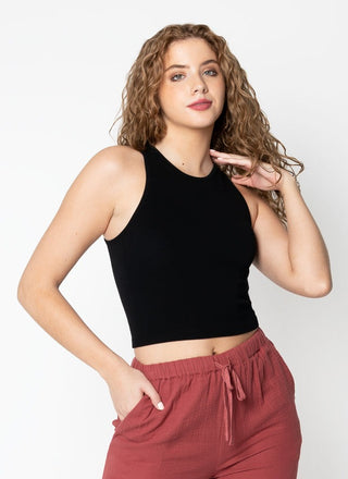 A woman wearing a black ribbed sleeveless tank top with a crew neck.