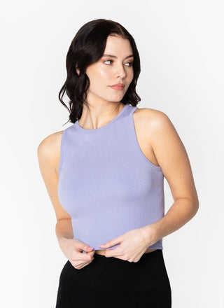 A woman wearing a purple ribbed sleeveless tank top with a crew neck.