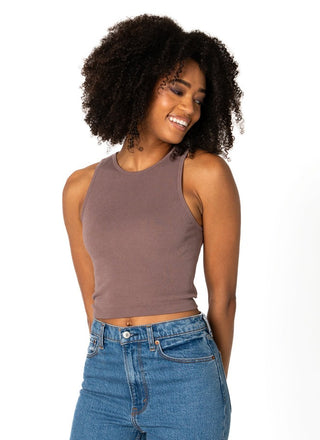 A woman wearing a brown ribbed sleeveless tank top with a crew neck.