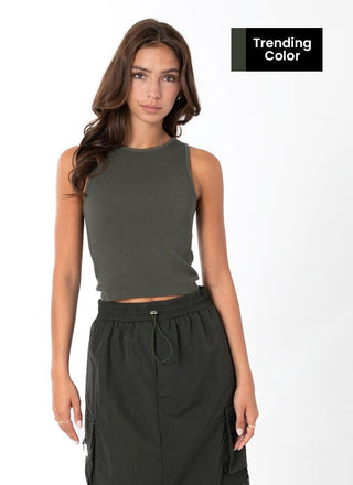 A woman wearing a green ribbed sleeveless tank top with a crew neck.