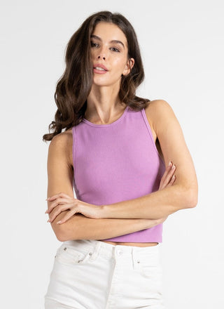 A woman wearing a purple ribbed sleeveless tank top with a crew neck.