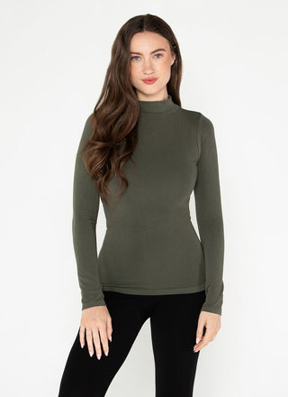 Woman wearing a green mock neck top made of bamboo