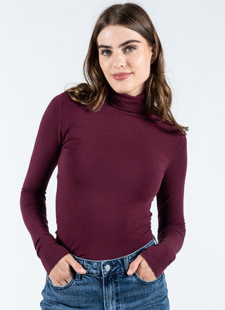 women wearing a burgundy bamboo turtleneck