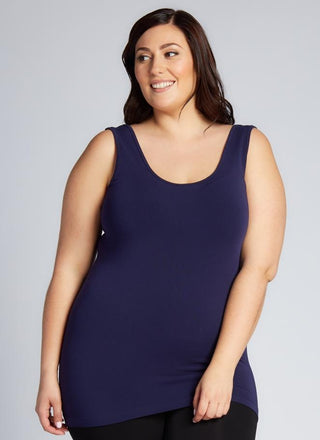 A woman wearing a Bamboo Curvy Classic Tank Top with thick straps and a scoop neckline.