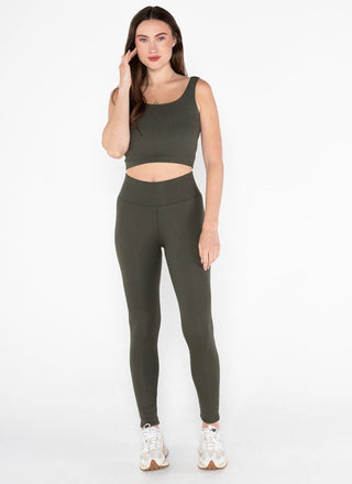 A woman wearing green sherpa lined leggings and a green crop top. 