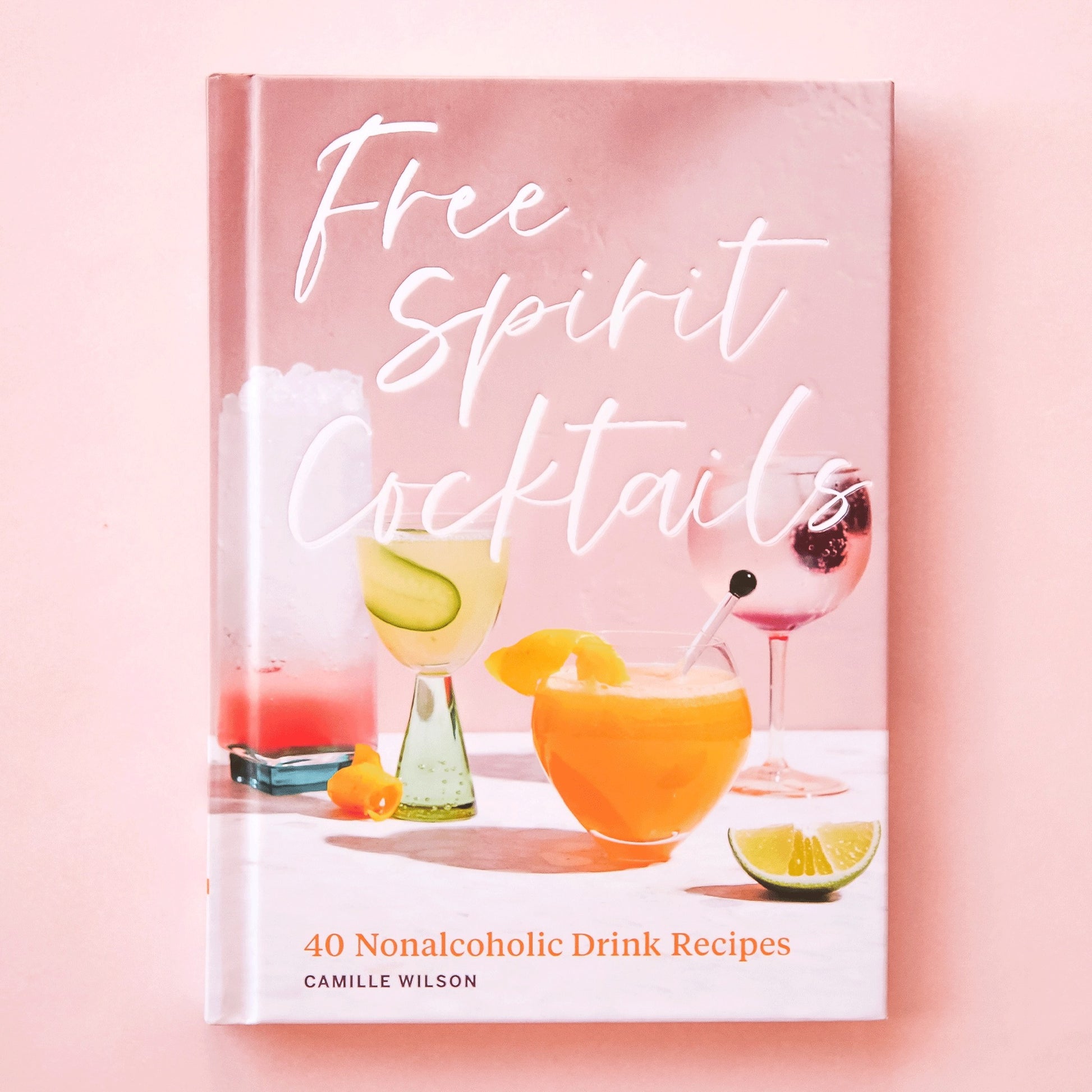 Book titled 'Free Spirit Cocktails' on a pink background