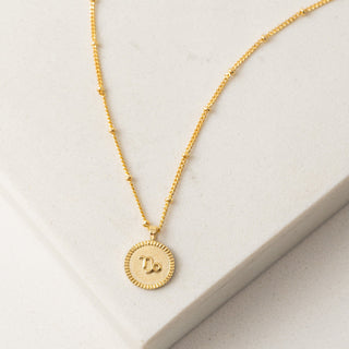 a capricorn gold circle necklace