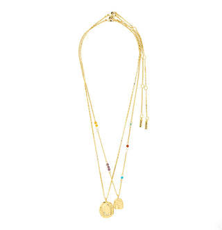Gold necklace with multiple pendants on a white background