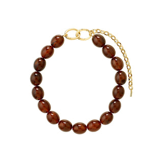 A beaded bracelet made of glossy, oval-shaped dark brown polished beads, featuring a gold-tone ring clasp and an adjustable gold-tone chain extender, shown on a plain white background.
