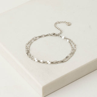 Silver bracelet on a light beige background