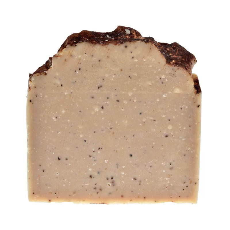 Block of cheese with a textured surface on a white background