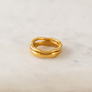 Gold ring on a light beige background