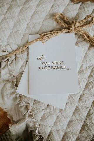 Note with 'You Make Cute Babies' text on textured fabric
