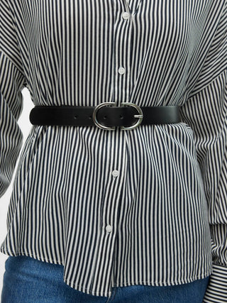 Black and white striped shirt with a black belt and blue jeans