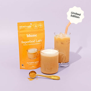 Blume Superfood Latte packaging with two glasses of pumpkin spice latte on a light purple background.