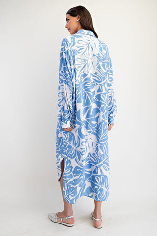 Woman wearing a blue and white floral dress on a white background