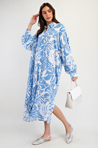 Woman wearing a blue and white leaf-patterned dress on a white background
