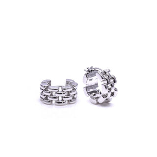 a pair of silver hoop earrings laying on a table