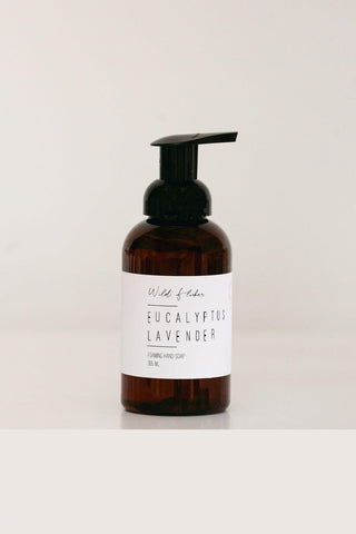 Brown bottle with pump and white label on a light gray background