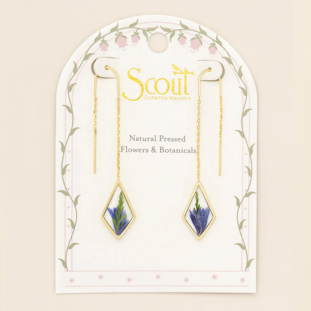 Gold earrings with natural pressed flowers on a Scout branded card.