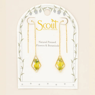 Jewelry card with earrings featuring natural pressed flowers and botanicals, branded 'Scout'.
