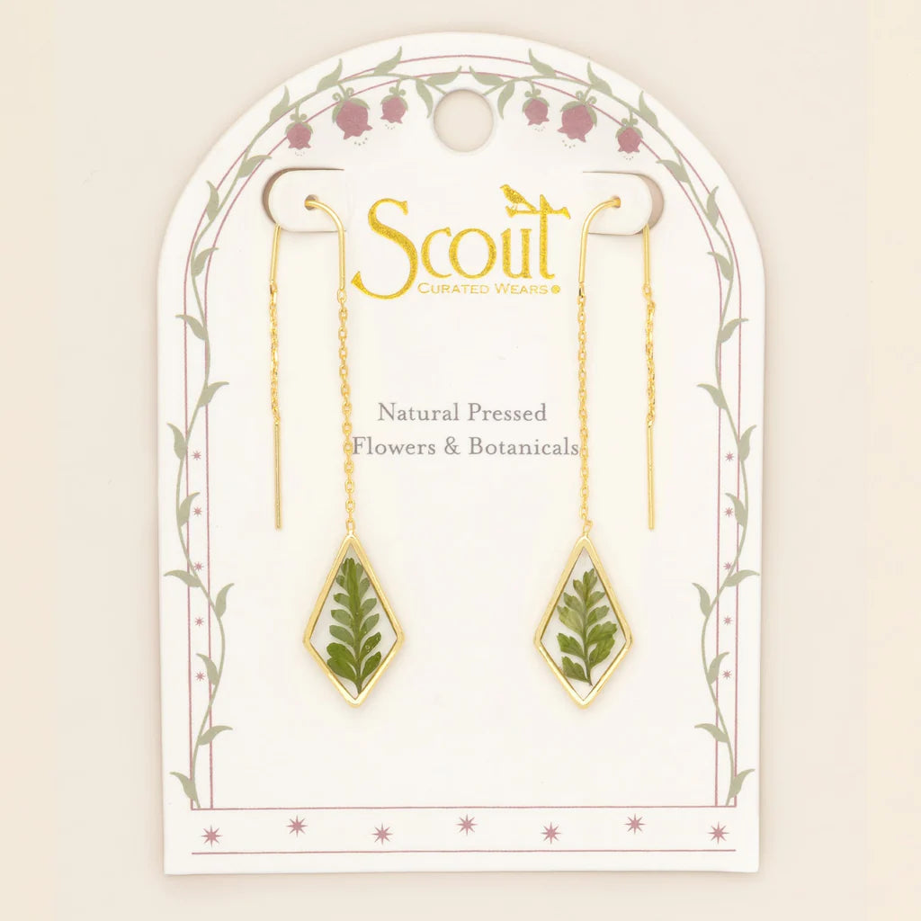 Gold earrings with natural pressed flowers on a Scout branded card.