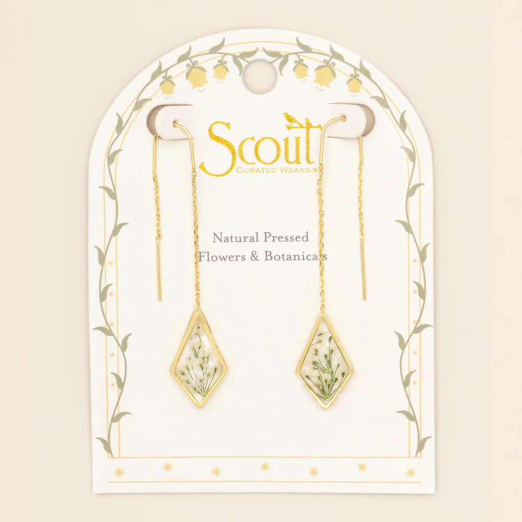 Gold earrings with natural pressed flowers on a Scout branded card.