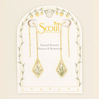 Gold earrings with natural pressed flowers on a Scout branded card.