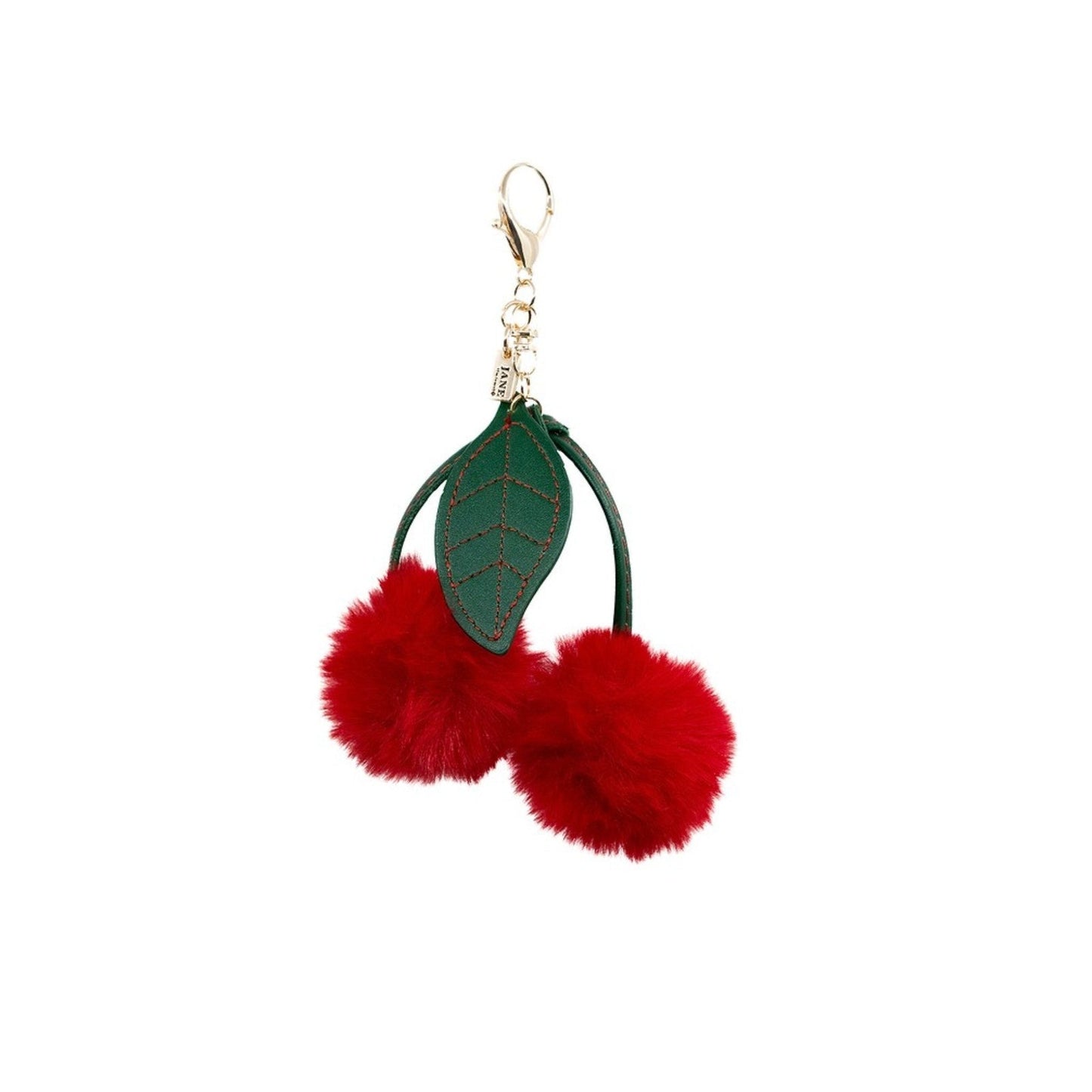 Keychain with red pom-poms and a green leaf on a white background