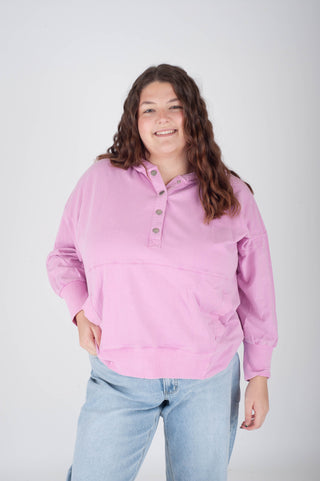 women wearing a pink henley style hoodie