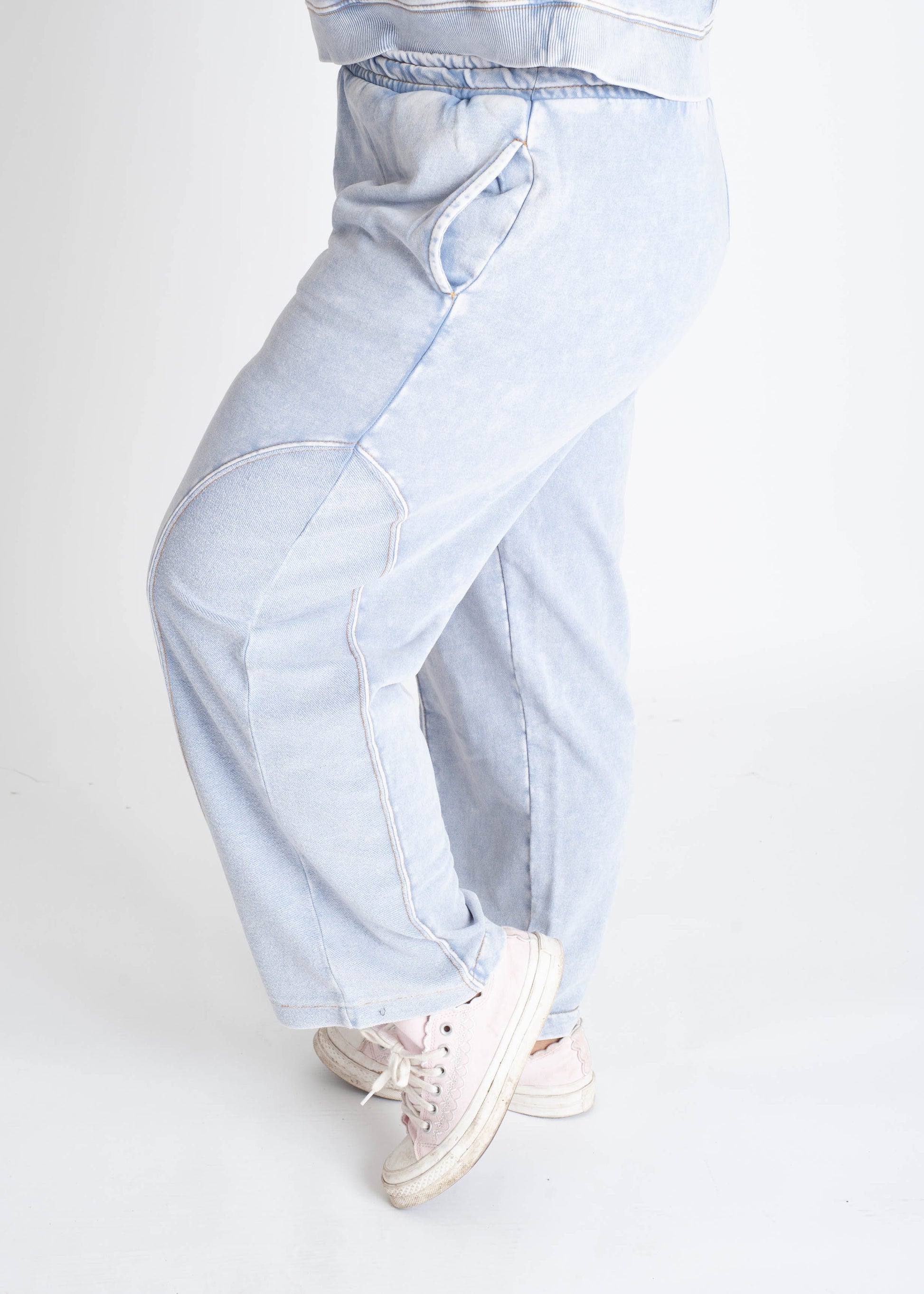 Light blue wide-leg jeans worn by a person on a white background