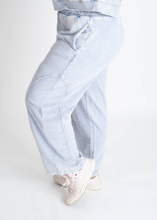 Light blue wide-leg jeans worn by a person on a white background