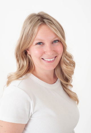 Women's headshot against a white background. 