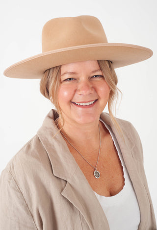 Women headshot in front a white background.