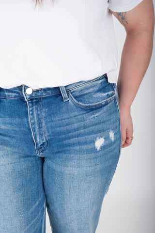 Person wearing blue jeans with a white background