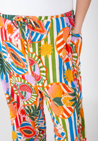 Colorful tropical fruit patterned pants on a white background