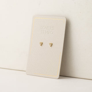 A pair of gold-plated stud earrings with cubic zirconia stones, displayed on a branded card