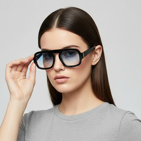 Woman wearing black sunglasses with a plain background