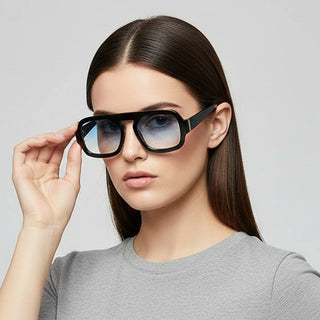 Woman wearing black sunglasses with a plain background