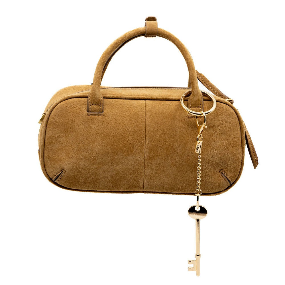 Brown handbag with a gold keychain on a white background
